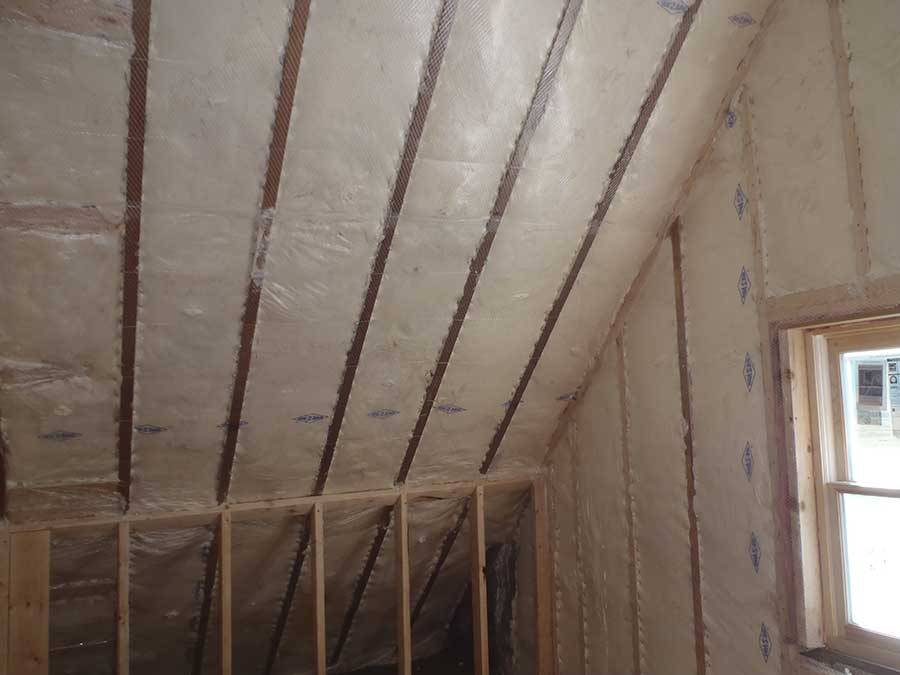 Batt Insulation fitted into attic walls for improved energy efficiency